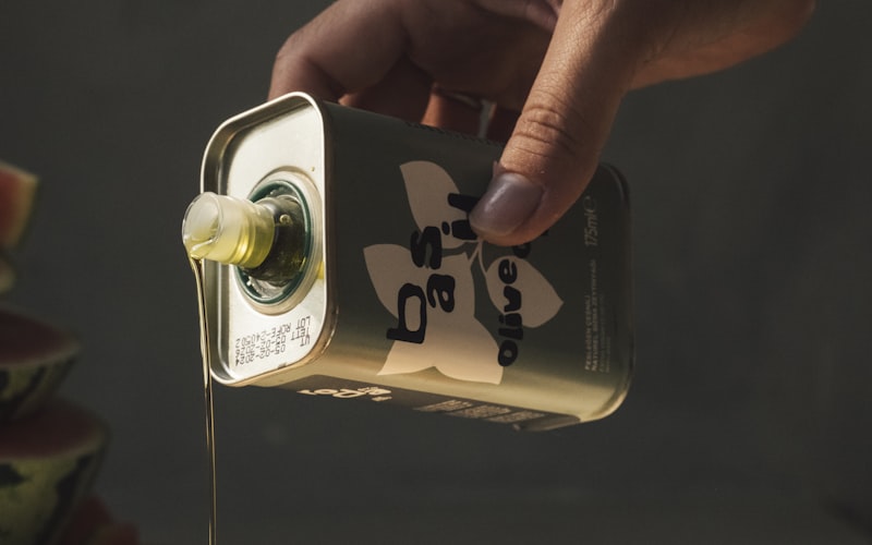 Olive oil being poured onto a fresh salad